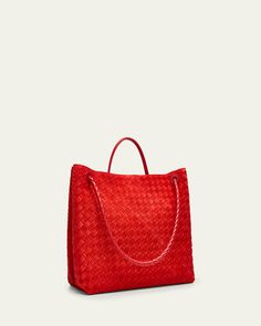 Bottega Veneta "Andiamo" tote bag in intreccio suede and leather     Rolled top handle     Shoulder strap    Can be worn as a top handle or shoulder bag     Open top with center knot drawstring strap     Interior, one zip pocket and two slip pockets     Approx. 13.8"H x 16.5"W x 7.1"D    Made in Italy