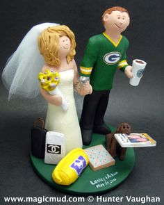 a wedding cake topper with a bride and groom holding coffee mugs on a green plate