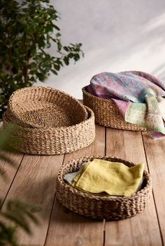 two wicker baskets sitting on top of a wooden table