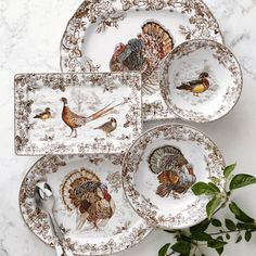 four plates with turkeys painted on them