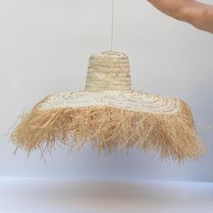 Step into a realm of bohemian charm with our handcrafted Straw Wall Hat. Each piece is meticulously woven from palm leaves, embodying the artisanal spirit and authenticity of Moroccan craftsmanship. Adorned with delicate raffia fringes, this hat adds a touch of whimsy and warmth to any space. Whether you hang it in your living room, bedroom, or even outdoors, its boho allure instantly elevates the ambiance. Perfect as a unique wall decor piece, this Moroccan-inspired hat also makes for an except Bohemian Brimmed Straw Hat Made Of Palm Leaf, Bohemian Brimmed Straw Hat From Palm Leaf, Bohemian Brimmed Straw Hat In Natural Material, Rustic Natural Straw Hat For Vacation, Bohemian Woven Straw Hat, Handmade Bohemian Straw Hat, Bohemian Wide Brim Straw Hat In Natural, Natural Wide Brim Bohemian Straw Hat, Bohemian Festival Sun Hat Made Of Palm Leaf