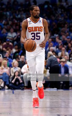 an image of a basketball player running with the ball in his hand during a game