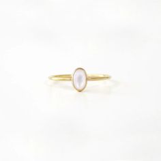 A small, delicate Gold Small Oval Pearl Ring is a delightful, feminine choice. Crafted from eco-friendly recycled gold and a sustainable gemstone, it is the perfect accessory to pair with any Sara Patino Jewelry look. The soft and luminous white pearl offers a timeless beauty that is both classic and modern. Recycled 14k gold filled Mother of Pearl is 6mm x 4mm Oval Pearl Ring, Elegant Oval Stackable Rings For Everyday, Elegant Stackable Rings For Everyday, Elegant Everyday Stackable Oval Rings, Minimalist Oval Cabochon Wedding Jewelry, Minimalist Oval Cabochon Wedding Ring, Dainty Oval Birthstone Ring, Delicate White Moonstone Ring In 14k Gold, Minimalist Oval Cabochon Opal Ring