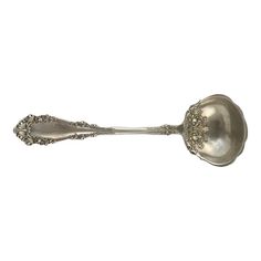 a silver spoon with an ornate design on it