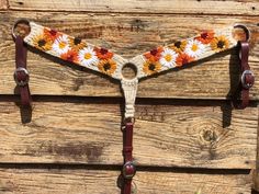 a close up of a horse bridle with flowers on it