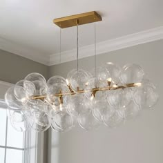 a chandelier with clear glass balls hanging from the ceiling