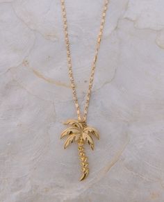 Royal Palm necklace | The Salty Babe Beachy Gold Jewelry For Vacation, Beachy Gold Vacation Jewelry, Gold Shell Necklace For Vacation, Beachy Style, Ocean-inspired Gold Necklaces For Vacation, Beachy Gold Shell-shaped Necklace, Palm Necklace, Swimming In The Ocean, Ocean Sunrise, Paris Jewelry