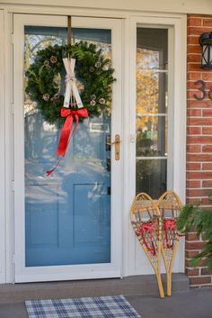 a blue front door with a wreath on it