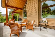 an outdoor patio with wicker chairs and tables