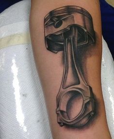 a tattoo on the arm of a person with a hammer and wrench in it