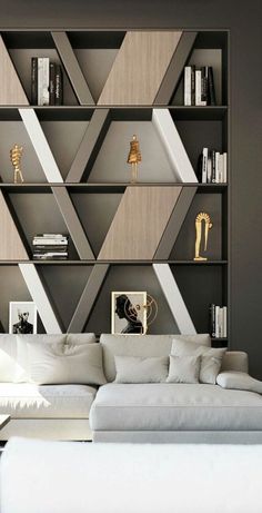 a white couch sitting in front of a book shelf