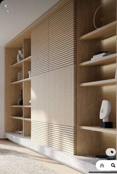 a living room filled with lots of furniture and bookshelves next to a window