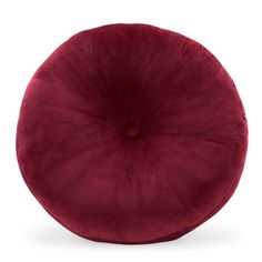 a red round pillow sitting on top of a white floor