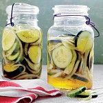 two jars filled with pickles and sliced cucumbers