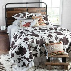 a bed with brown and white cow print on it