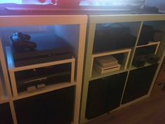 an entertainment center with several different types of electronic equipment on it's sides and shelves