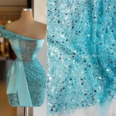 a blue dress with sequins on it and a mannequin in the background