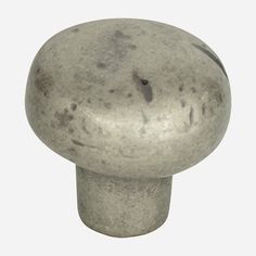 a metal knob on a white background with no image to describe, it is an object that appears to be made out of concrete