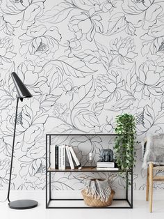 the wallpaper in this living room is painted with black and white flowers