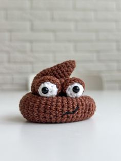 a brown crocheted stuffed animal with eyes