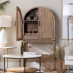 a living room filled with furniture next to a wall mounted wine rack and vases