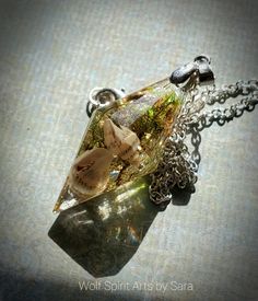 "These magical pendulum-style pendants contains real elements of Nature forever in resin! There's 3 to choose from! One has \"seaweed\" and shells for Ocean-vibes, one has rose petals and purple flowers, and one has an Apple Aura Quartz with Moss! To invite these pieces into your life is to invite in a little bit of magick! Each piece is a one-of-a-kind that is created with intention and a piece of my heart and soul goes into each one. They are also cleansed and charged with the intention to cal Mystical Resin Necklaces For Gifts, Amber Resin Pendant Necklace, Silver Resin Spiritual Necklace, Silver Spiritual Resin Necklace, Lunar Witch, Wiccan Decor, Elven Jewelry, Necklace Resin, Jewelry Resin