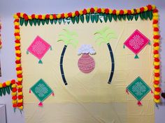 a decorated wall with paper decorations on it and palm trees in the center, surrounded by other items