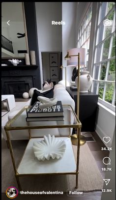 a living room filled with furniture and a large mirror on top of the coffee table