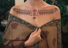 a woman with a tattoo on her chest