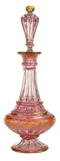 a pink glass vase sitting on top of a table