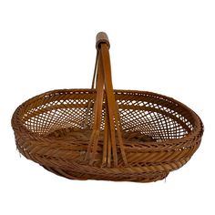 a wicker basket with two wooden handles on the bottom and one handle in the middle