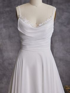 a white wedding dress on a mannequin