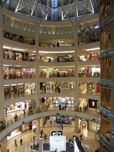 the inside of a shopping mall filled with people