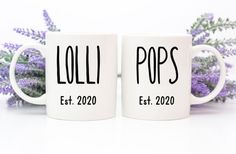 two coffee mugs with the words lolli pops on them