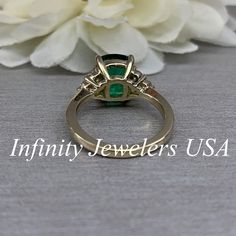 "This ring is an elongated cushion cut lab created green emerald with moissanite accents made with solid 14k yellow gold item #6650 We feature the finest quality lab grown emeralds in the world. The properties of lab-grown are physically, chemically and visually identical to natural, just grown in a lab setting. Emerald is the birthstone of May -Approximate total carat weight: 3.80ctw diamond equivalent -Center Stone Size: 10x8mm approx. 3.50ct diamond equivalent -Center Stone Shape: elongated c Gia Certified Rectangular Emerald Ring For Anniversary, Gia Certified Emerald Anniversary Ring, Elegant Marquise Cut Emerald Ring, Elegant Green Marquise Cut Emerald Ring, Green Baguette Cut Jewelry With Accent Stones, Formal Emerald Birthstone Ring In Rectangular Shape, Emerald Jewelry With Marquise Cut Center Stone, Formal Emerald Ring With Accent Stones For May Birthstone, Oval Emerald Ring With Accent Stones