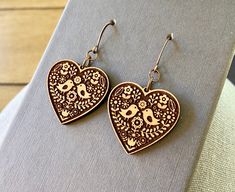 Folk Art Heart Cherry Wood Earrings.  Laser Cut.  Engraved. This is a unique and bold statement earring.   Heart measures 1.2 inches tall.  Laser cut to perfection.  All wood.   Made in USA.  Each piece of jewelry is designed, laser-cut,  and assembled by me. Gift Box included. Cheap Black Laser Engraved Jewelry, Wood Laser Engraving Machine, Folk Art Heart, Laser Cut Wood Jewelry, Homemade Signs, Laser Cut Wood Crafts, Laser Cut Jewelry, Laser Cut Earrings, Shop Name