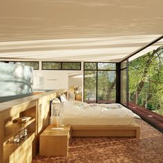 a bedroom with a large bed sitting next to a wooden dresser and window sill