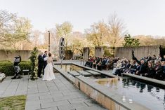 a bride and groom standing in front of an outdoor ceremony