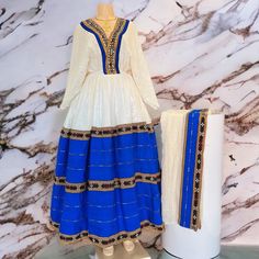 Beautiful Ethiopian and Eritrean Habeshan Dress. Stylish Menen, 100% Cotton We recommend hand washing and air drying to make it last longer. A low heating iron will also keep design and look. Cotton Traditional Free Size Dress For Eid, Traditional Free-size Eid Dresses, Ceremonial White Dabka Dresses, Blue Ceremonial Dress With Traditional Drape, Blue Maxi Dress For Traditional Ceremonies And Festive Occasions, Ceremonial Anarkali Dress With Long Sleeves, Traditional Free Size Maxi Dress, Bollywood Style Long Sleeve Ceremonial Dress, Ceremonial Long Sleeve Dresses With Dupatta