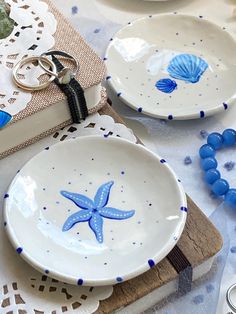 two white plates with blue starfish designs on them