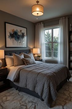 a bedroom with a large bed and two lamps on either side of the window sill