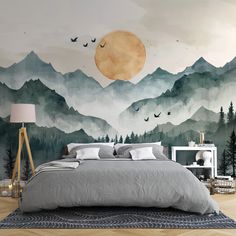 a bedroom with mountains and birds painted on the wall above the bed, along with a night sky mural