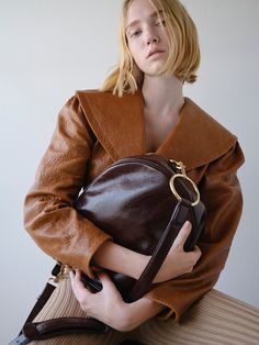 BLINI CIRCLE MEDIUM PLUM – FRAME Fall Evening Shoulder Bag With Leather Lining, Timeless Shoulder Bag For Travel In Fall, Luxury Leather Lined Shoulder Bag For Fall, Luxury Cognac Shoulder Bag For Fall, Vintage Bags With Leather Lining For Fall, Cognac Shoulder Bag With Detachable Strap For Fall, Fall Cognac Shoulder Bag With Detachable Strap, Vintage Formal Shoulder Bag For Fall, Brown Shoulder Bag With Leather Lining And Round Handle