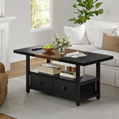 a living room with a couch, coffee table and two drawers on the bottom shelf