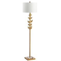 a gold floor lamp with a white shade