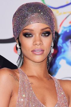 a close up of a person wearing some kind of headdress and jewelry on her face