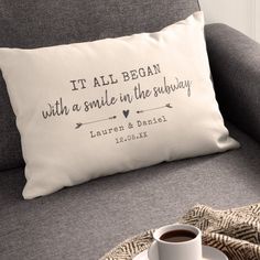 a pillow that says it all begun with a smile in the bubbly and a cup of coffee