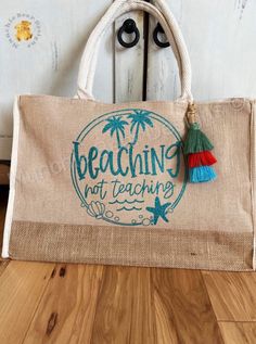 "Handmade with love 💓, this beautiful jute tote is the perfect gift for the teacher in your life! Great bag to carry to the beach or on-the-go! Gift this to yourself or your favorite teacher! Featuring \"Beaching not Teaching\" in HTV (heat transfer vinyl) on the front. Available with or without an adorable boho chic tassel. TASSEL COLORS MAY VARY!  HTV colors available include: Burgundy, Black, Aqua Blue (as pictured), Hot Pink, or Purple. Note: there are no pockets.  - 17 1/2\"W x 11 1/2\"H x Beige Bags For Beach Season Gift, Bohemian Sand Colored Beach Bag For Beach Season, Bohemian Sand-colored Beach Bag For Beach Season, Sand-colored Beachy Beach Bag For Vacation, Bohemian Sand-colored Beach Bag, Rectangular Beach Bag Gift For Summer, Eco-friendly Bags For Summer Gifts, Eco-friendly Bags As Summer Gifts, Rectangular Beach Bag As Summer Gift