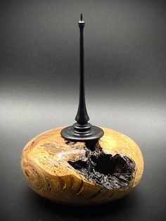 a small candle holder made out of wood and metal