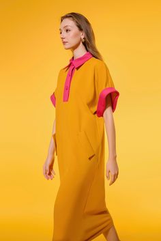 This dress is crafted from soft cotton, featuring a straight, wide-sleeved cut for a flattering yet relaxed fit. Its timeless silhouette will lend effortless sophistication to any look. Oversized Short Sleeve Dresses For Work, Oversized Short Sleeve Workwear Dress, Relaxed Fit Dresses With Cuffed Sleeves, Yellow Casual Shirt Dress For Work, Casual Yellow Shirt Dress For Work, Collared Yellow Dress For Work, Elegant Yellow Shirt Dress For Work, Yellow Midi Shirt Dress For Work, Oversized Workwear Dresses With Placket